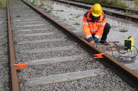 Signal maintainer placing a shunt on the track.